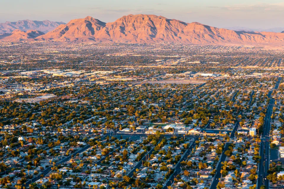 Aerial view of housingin Las Vegas, Nevada with desert mountains in background.